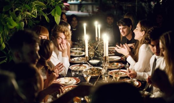 People dining outdoors with a candlelight