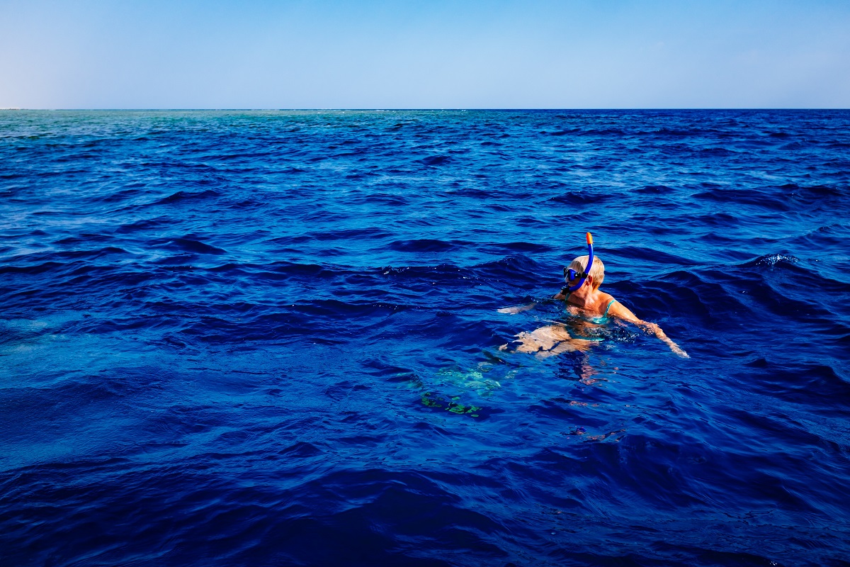 Snorkeling alone in a blue sea